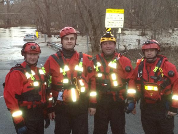 Strike Team-740 after successfully rescuing a person from the car being swept downstream. Car is in the background.